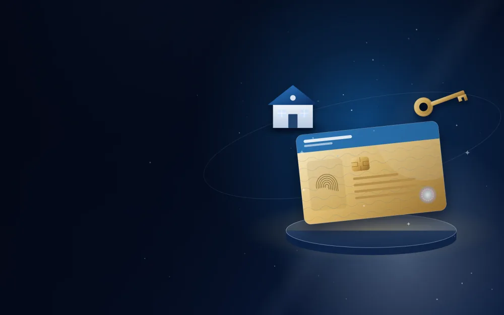 Gold long-term residence card on a display stand with a golden key and a home
